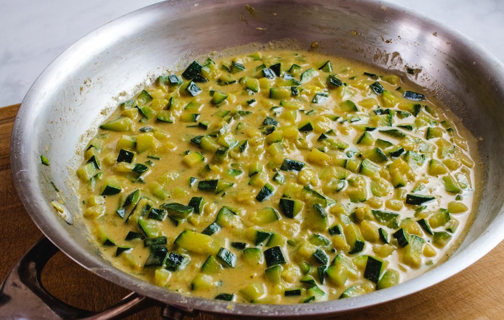 curried zucchini in a silver frying pan