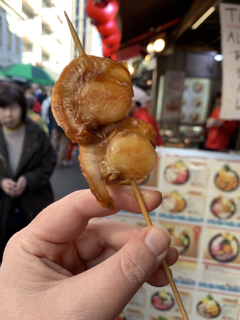 two grilled scallops on a skewer