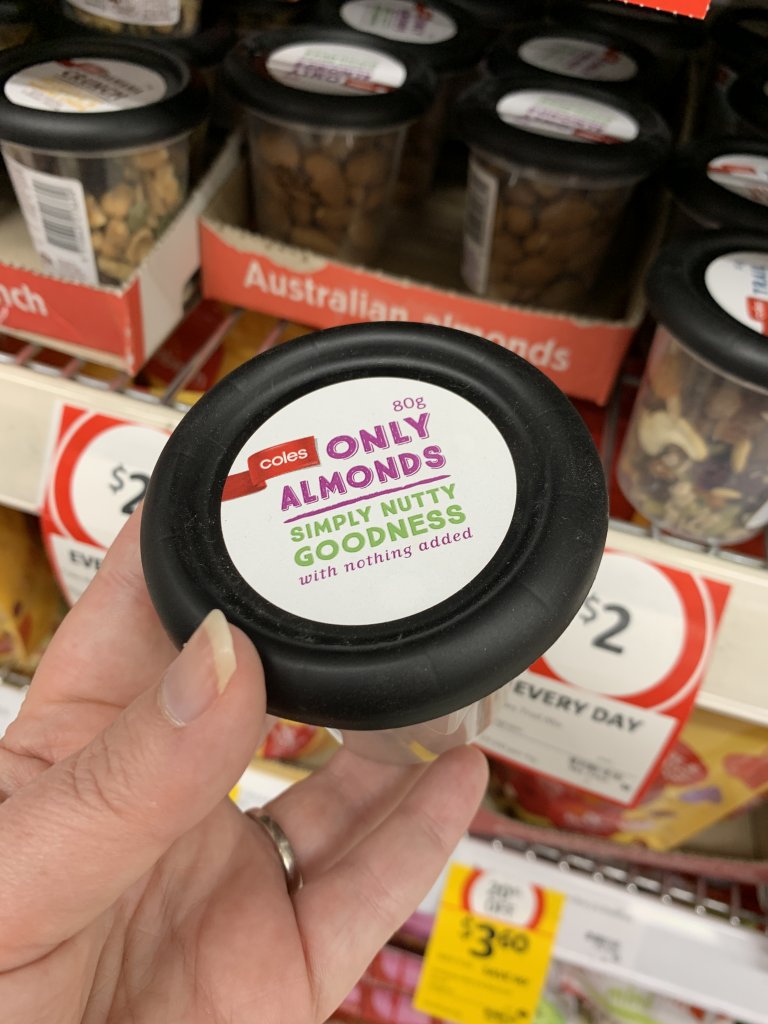 Hand holding Almonds snack pack. A perfect keto snack at Coles. 