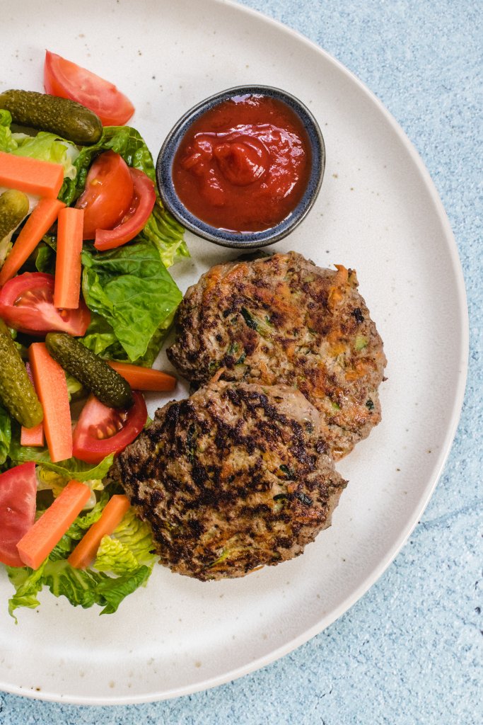 Beef rissoles with a side salad and tomato sauce
