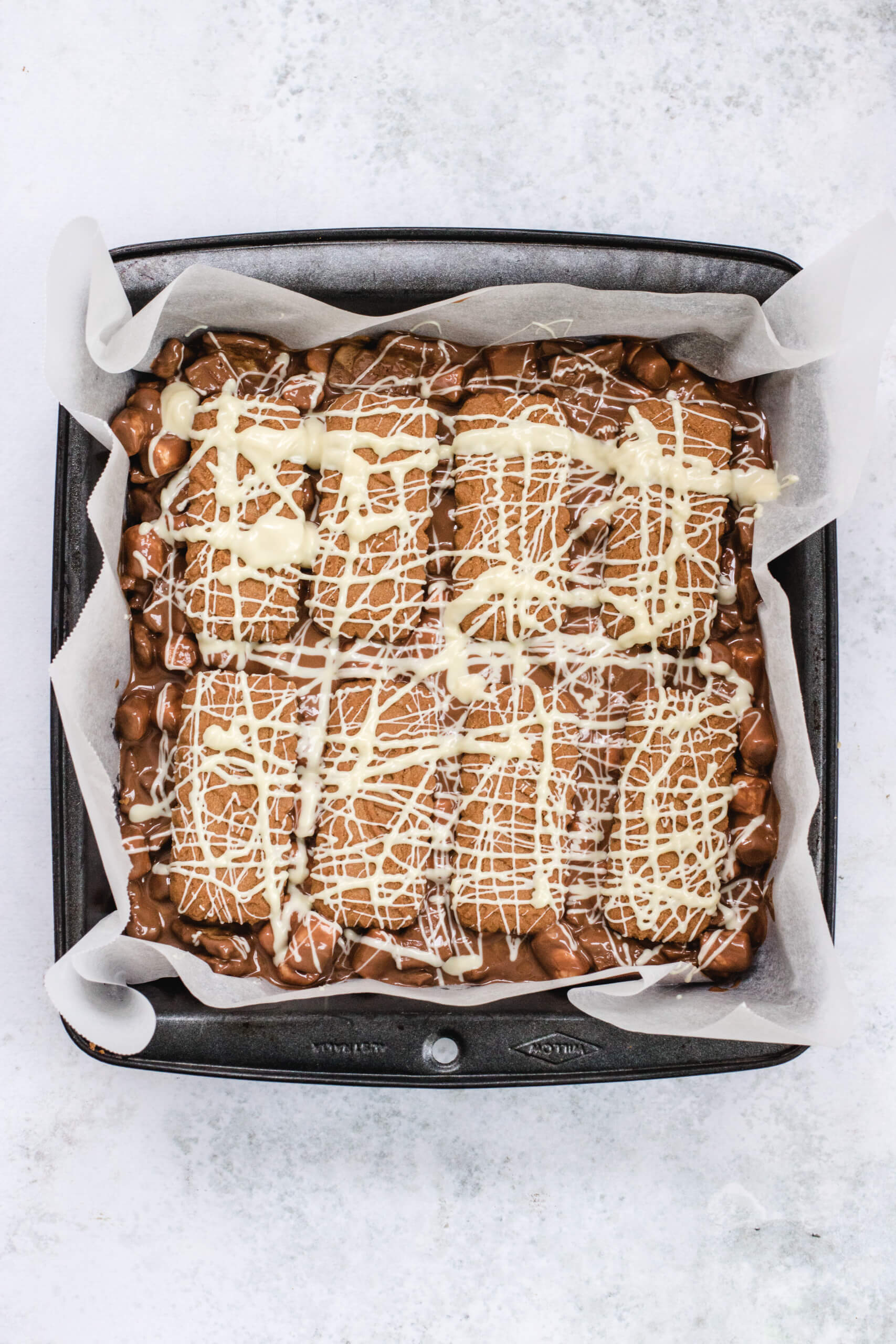Biscoff rocky road in the square black tin with baking paper.
