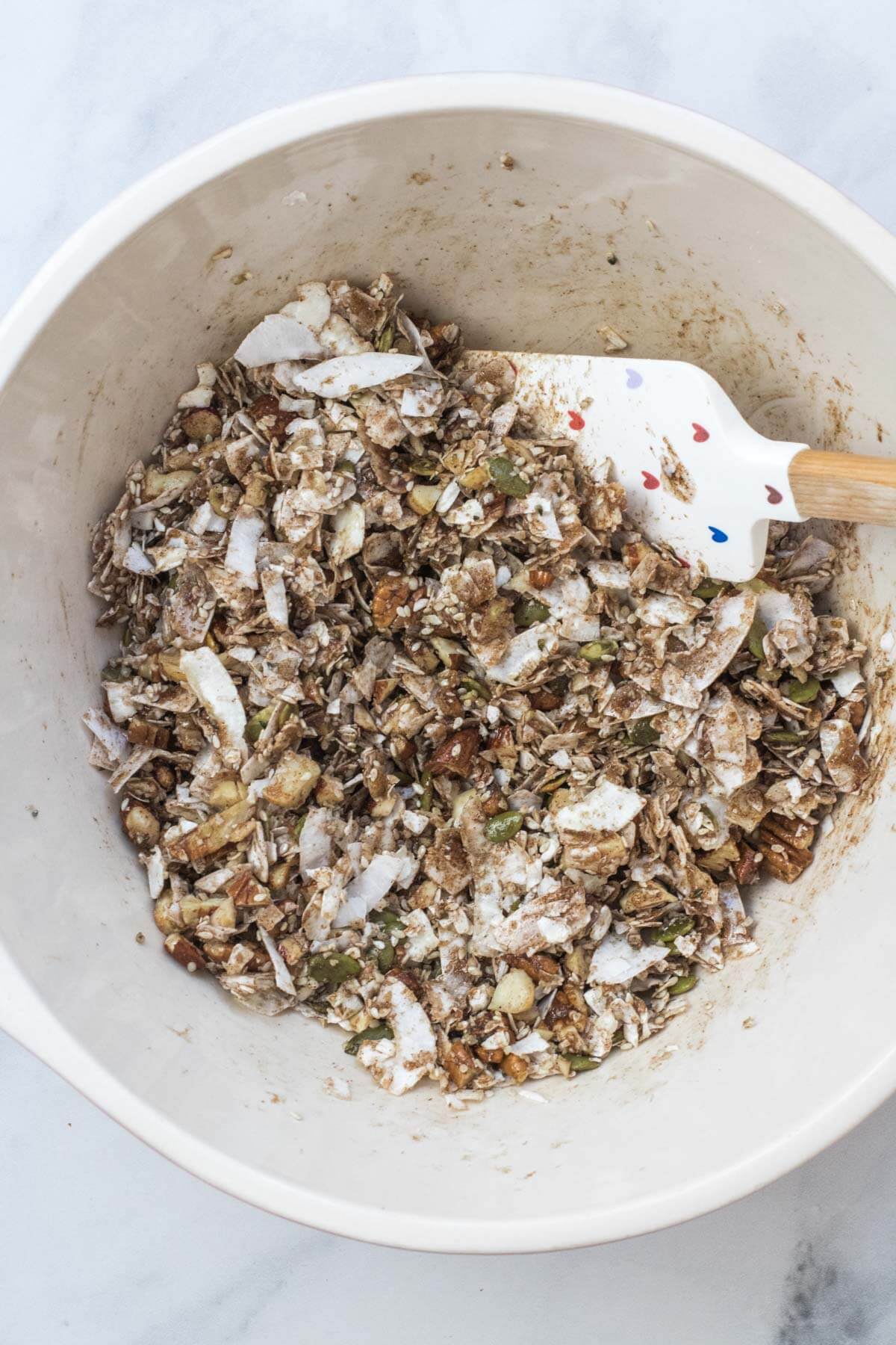 Granola ingredients all combined in a bowl.